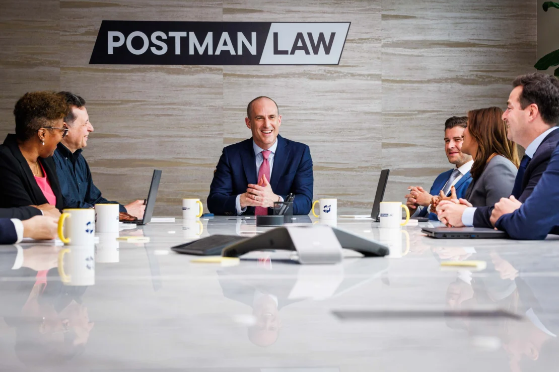 Un grupo de abogados en una reunión en Postman Law.